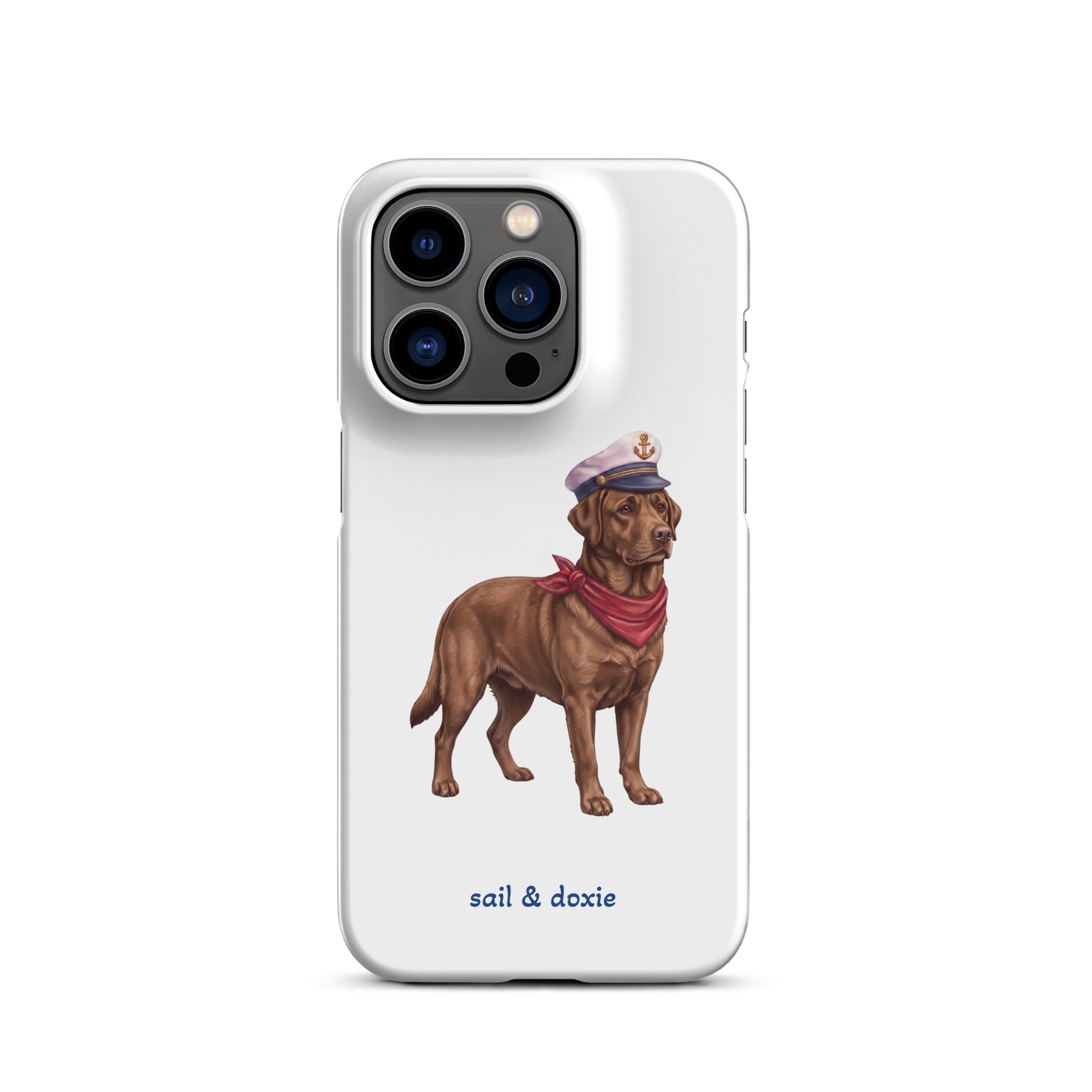 A white phone case featuring an illustration of a brown Labrador dressed as a sailor with a captain's hat and red neck scarf, with the text 'sail & doxie' printed below.