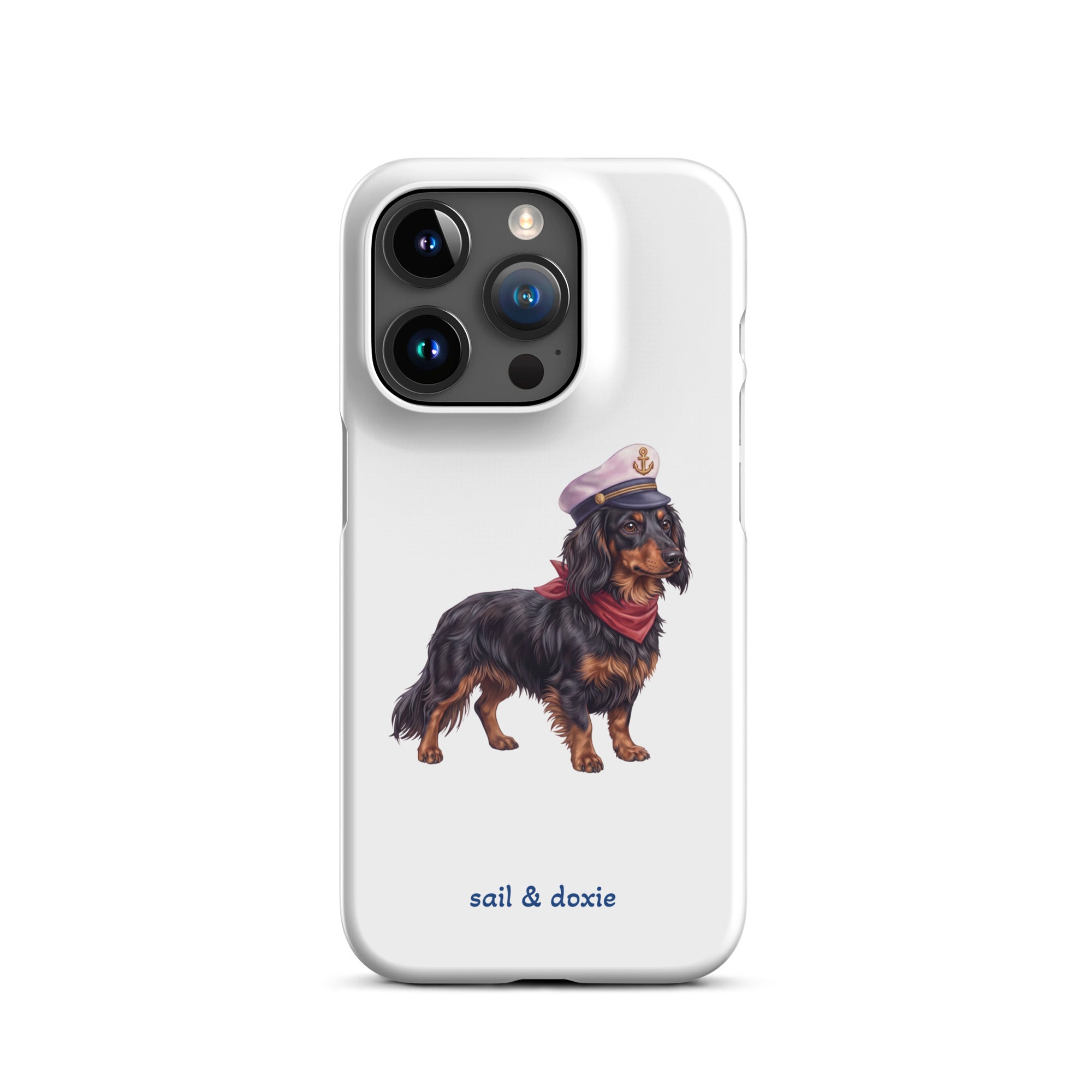 A white phone case featuring an illustration of a black and tan dachshund wearing a captain's hat and red neckerchief, with the text 'sail & doxie' printed below in blue. The case is shown on a clean white background.