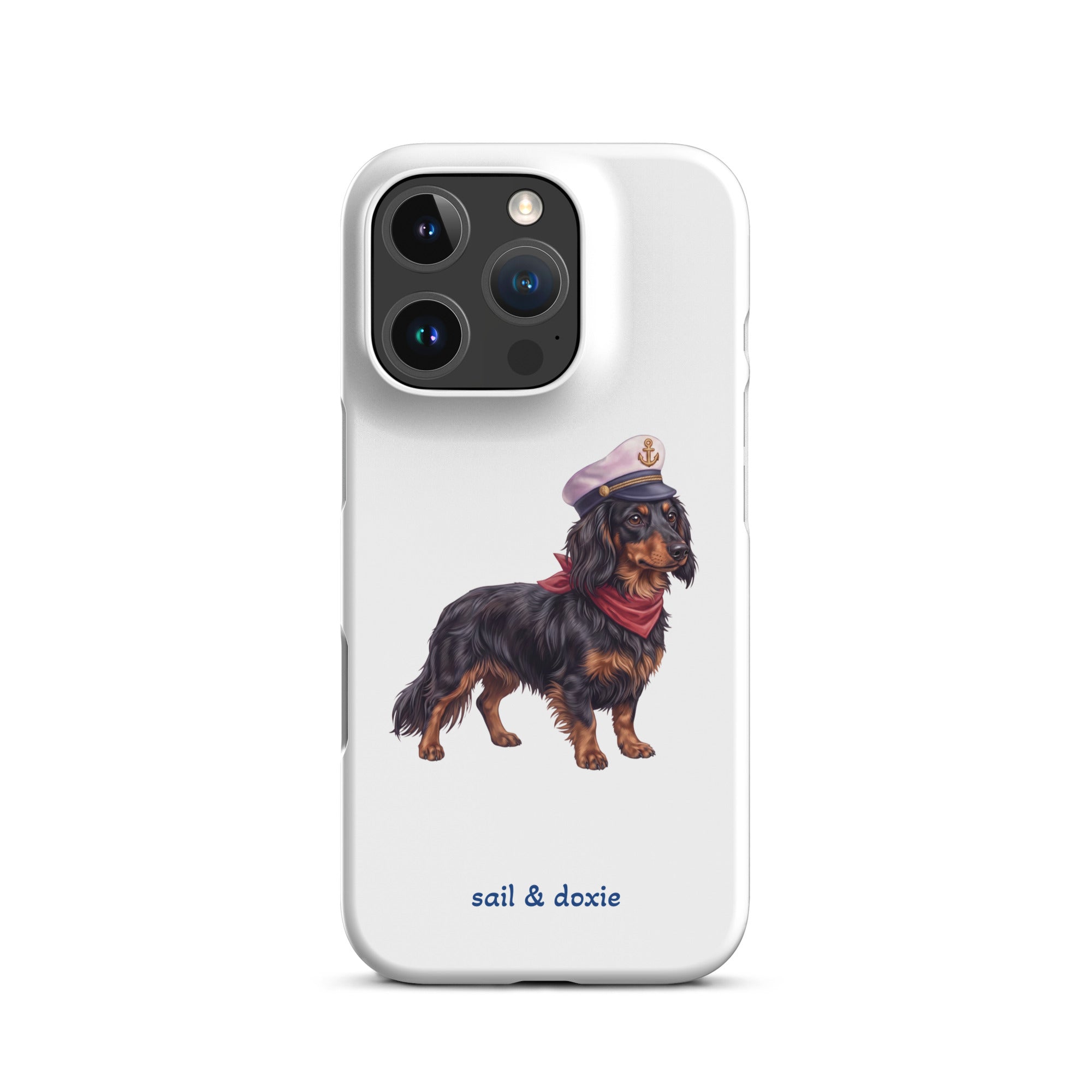 A white phone case featuring an illustration of a black and tan dachshund wearing a captain's hat and red neckerchief, with the text 'sail & doxie' printed below in blue. The case is shown on a clean white background.